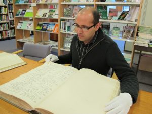 Bhaskhar Adhikari consulting one of RBGE's copies of the Wallich Catalogue