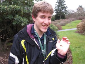 MSc student Tom Dawes with one of the moths from the Garden's new moth traps.