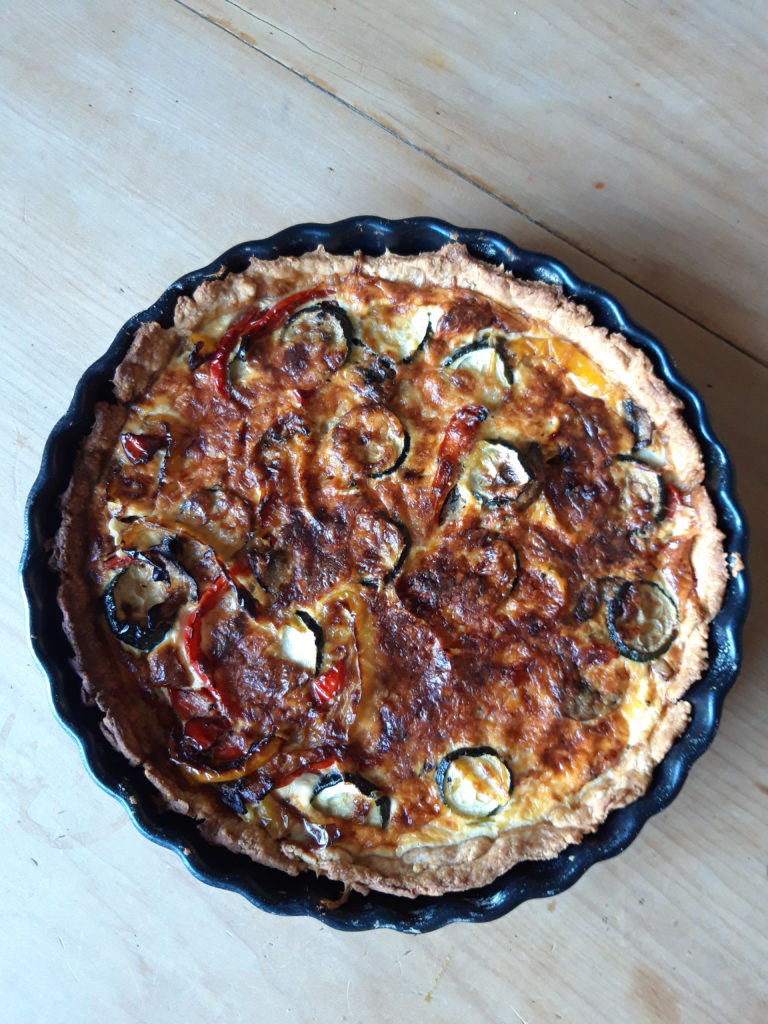 Photo shows a roasted vegetable quiche straight out of the over