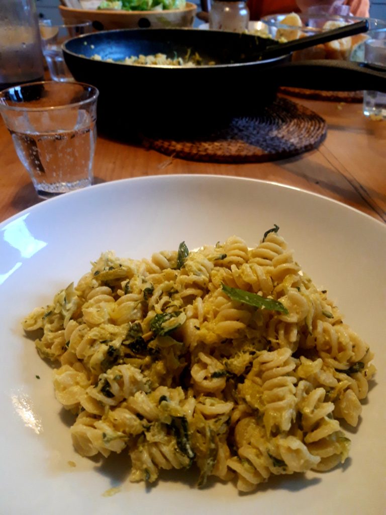 A bowl of fussili pasta with a sauce made from courgettes