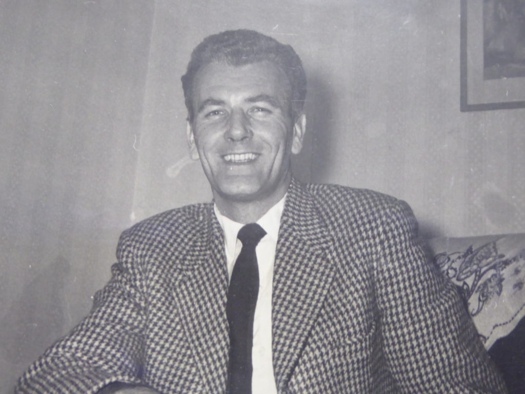 Black and white photograph showing Ross Eudall smiling.
