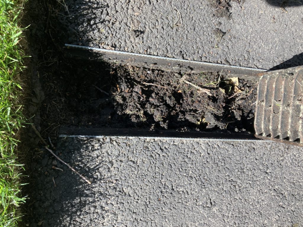 Drainage channel blocked with hort mulch