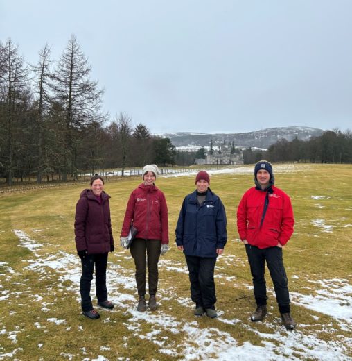 Four people in the snow outside the Balmoral Castle