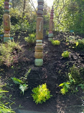 Slope with nature-inspired clay artwork in the form of columns