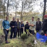Group of conservationists at Loch Arkaig in Scotland having just completed a recovery planting of alpine blue-sow-thistle, a threatened native plant