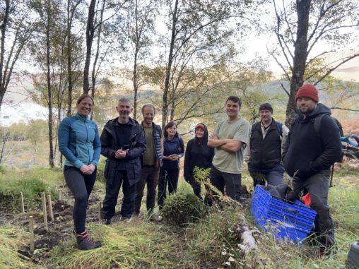 Group of conservationists at Loch Arkaig in Scotland having just completed a recovery planting of alpine blue-sow-thistle, a threatened native plant