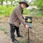 Upright coral interpretation Colin installing panel